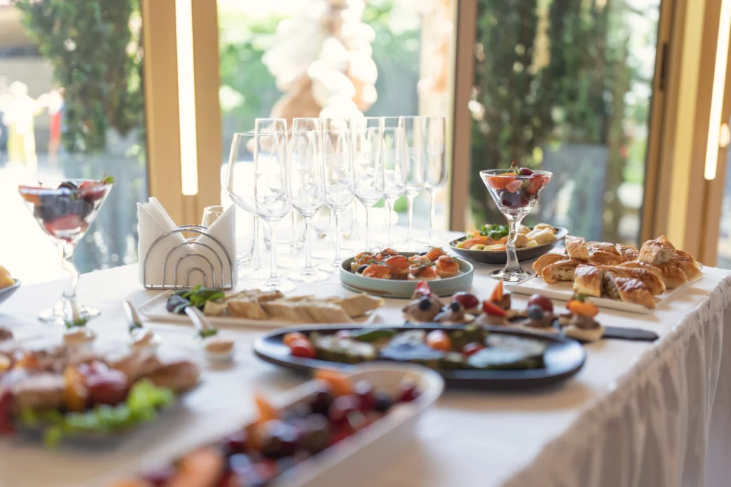 A wedding brunch feast with pastries, fruits, and glasses for mimosas