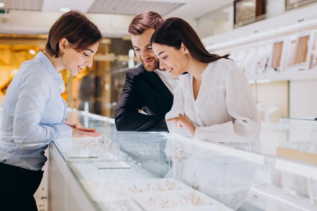 A couple in a jewellery store picking out wedding rings