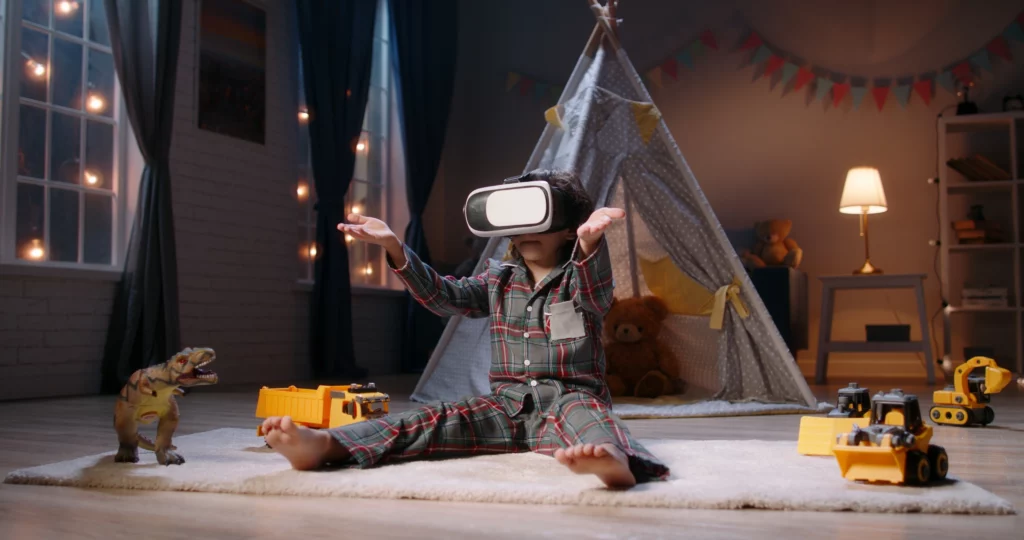 A young child in a playful bedroom at night, surrounded by toy trucks and dinosaurs, and wearing a VR headset