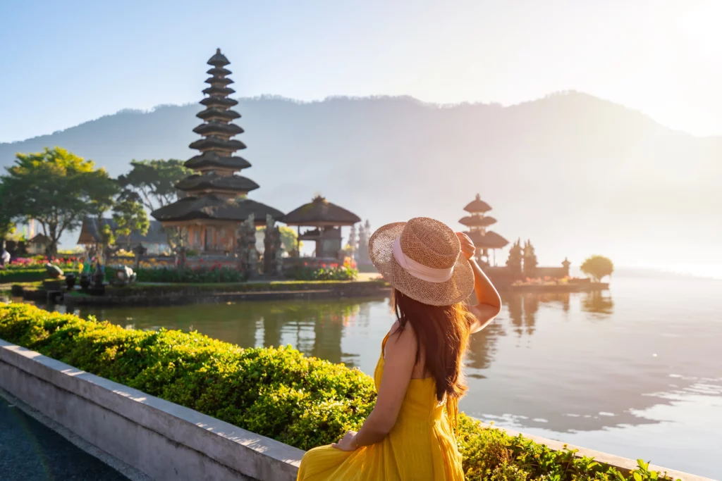 A woman in Bali looks out over a lake